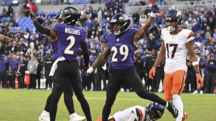 Nov 3, 2024; Baltimore, Maryland, USA; Baltimore Ravens cornerback Nate Wiggins (2) and =safety Ar'Darius Washington (29) celebrate after tackling Denver Broncos wide receiver Courtland Sutton (14) on the one yard line on fourth down  the  during the  half at M&T Bank Stadium. Mandatory Credit: Tommy Gilligan-Imagn Images