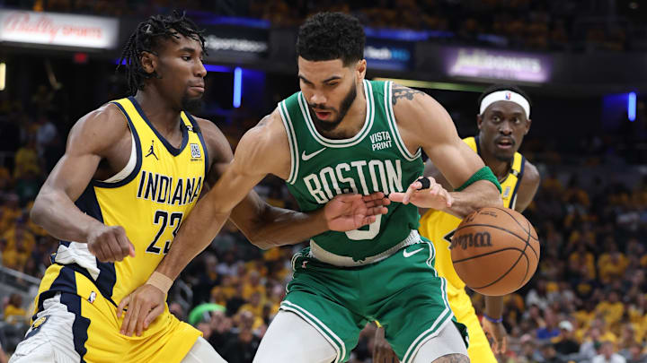 May 25, 2024; Indianapolis, Indiana, USA; Boston Celtics forward Jayson Tatum (0) looses control of the ball against Indiana Pacers forward Aaron Nesmith (23) during the third quarter of game three of the eastern conference finals in the 2024 NBA playoffs at Gainbridge Fieldhouse. Mandatory Credit: Trevor Ruszkowski-Imagn Images