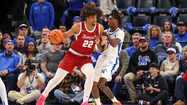Feb 9, 2025; Memphis, Tennessee, USA; Temple Owls forward Elijah Gray (22) drives against Memphis Tigers guard PJ Carter (7) during the first half at FedExForum.