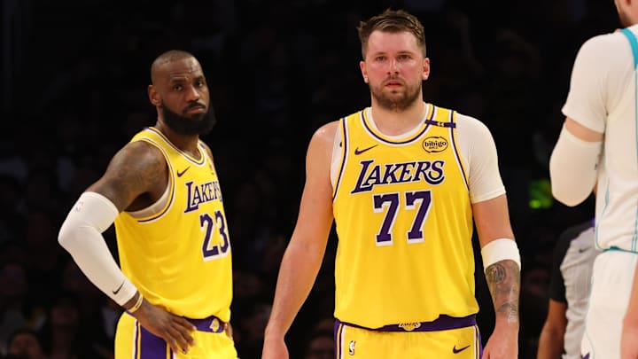 Feb 19, 2025; Los Angeles, California, USA; Los Angeles Lakers forward LeBron James (23) and guard Luka Doncic (77) during the second quarter against the Charlotte Hornets at Crypto.com Arena. Mandatory Credit: Jason Parkhurst-Imagn Images