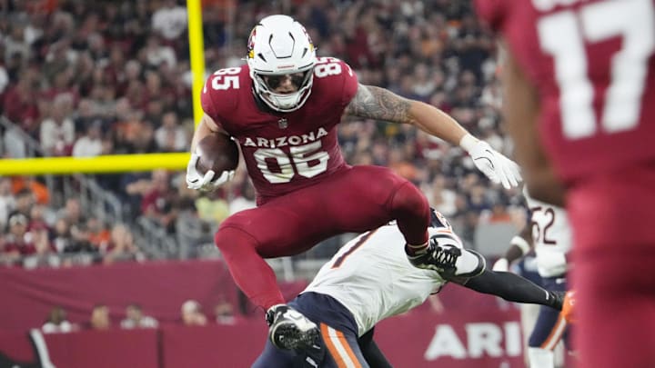 Arizona Cardinals tight end Trey McBride (85) jumps over Chicago Bears cornerback Jaylon Johnson (1) during the third quarter at State Farm Stadium on Nov 3, 2024, in Glendale.