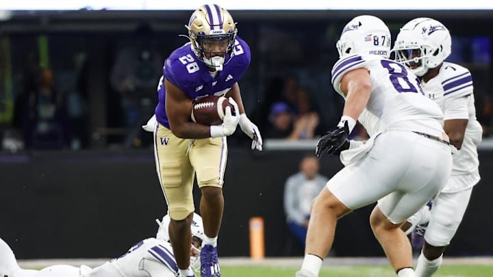 Sep 21, 2024; Seattle, Washington, USA; Washington Huskies linebacker Khmori House (28) returns an interception against the Northwestern Wildcats during the fourth quarter at Alaska Airlines Field at Husky Stadium. Mandatory Credit: Joe Nicholson-Imagn Images