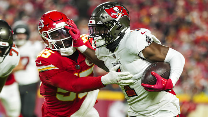 Nov 4, 2024; Kansas City, Missouri, USA; Tampa Bay Buccaneers running back Rachaad White (1) runs the ball against Kansas City Chiefs linebacker Joshua Uche (55) during the first half at GEHA Field at Arrowhead Stadium. Mandatory Credit: Jay Biggerstaff-Imagn Images
