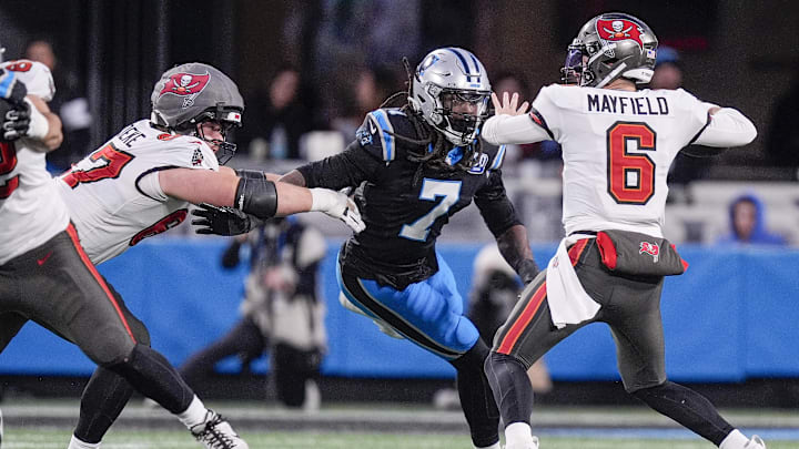 Dec 1, 2024; Charlotte, North Carolina, USA; Tampa Bay Buccaneers quarterback Baker Mayfield (6) throws under pressure from Carolina Panthers linebacker Jadeveon Clowney (7) during the second quarter at Bank of America Stadium. Mandatory Credit: Jim Dedmon-Imagn Images Dec 1, 2024; Charlotte, North Carolina, USA; Tampa Bay Buccaneers quarterback Baker Mayfield (6) throws under pressure from Carolina Panthers linebacker Jadeveon Clowney (7) during the second quarter at Bank of America Stadium. Mandatory Credit: Jim Dedmon-Imagn Images