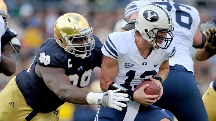 Oct. 20, 2012; South Bend, IN, USA; Notre Dame Fighting Irish defensive end Kapron Lewis-Moore (89) sacks BYU Cougars quarterback Riley Nelson (13) in the first quarter at Notre Dame Stadium. Mandatory Credit: Matt Cashore-USA TODAY Sports