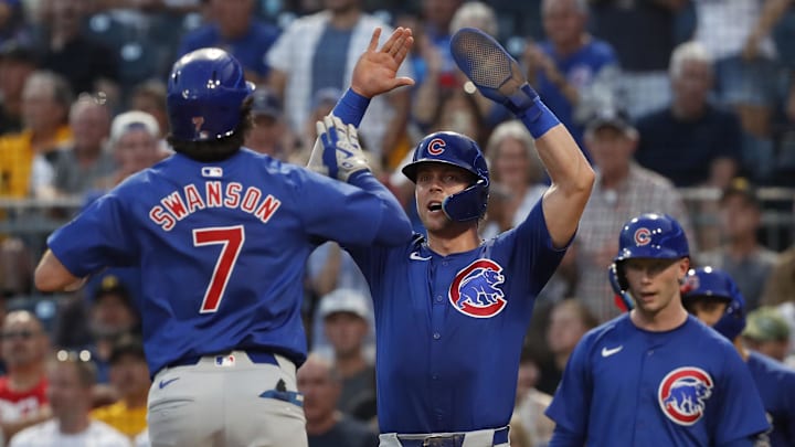 Aug 27, 2024; Pittsburgh, Pennsylvania, USA;  Chicago Cubs second baseman Nico Hoerner (middle) greets shortstop Dansby Swanson (7) crossing home plate on a two-run home run against the Pittsburgh Pirates during the fourth inning at PNC Park. Mandatory Credit: Charles LeClaire-Imagn Images