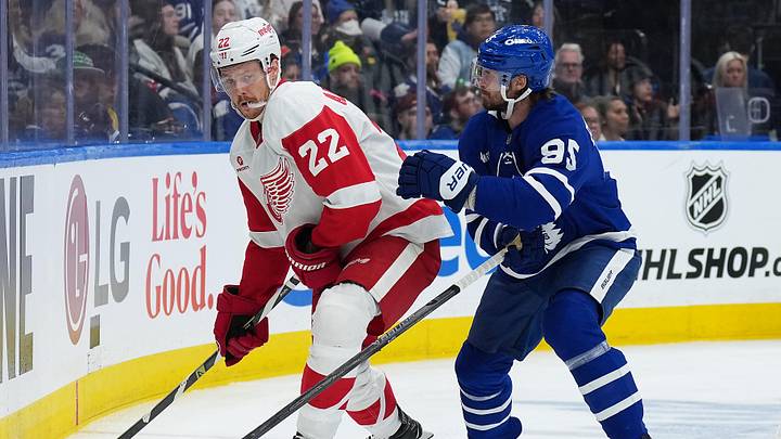 Oct 2, 2025; Toronto, Ontario, CAN; Detroit Red Wings defenseman Shai Buium (22) battles for the puck with Toronto Maple Leafs defenseman Oliver Ekman-Larsson (95) during the second period at Scotiabank Arena. Mandatory Credit: Nick Turchiaro-Imagn Images