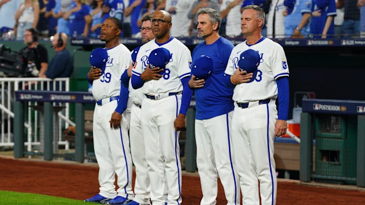 Oct 10, 2024; Kansas City, Missouri, USA; Kansas City Royals manager Matt Quatraro (33) and coaching staff stand for the national anthem against the New York Yankees prior to game four of the NLDS for the 2024 MLB Playoffs at Kauffman Stadium. Mandatory Credit: Denny Medley-Imagn Images