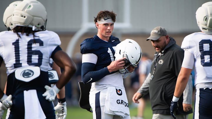 Penn State Nittany Lions quarterback Drew Allar puts his helmet on during a practice session outside Holuba Hall.