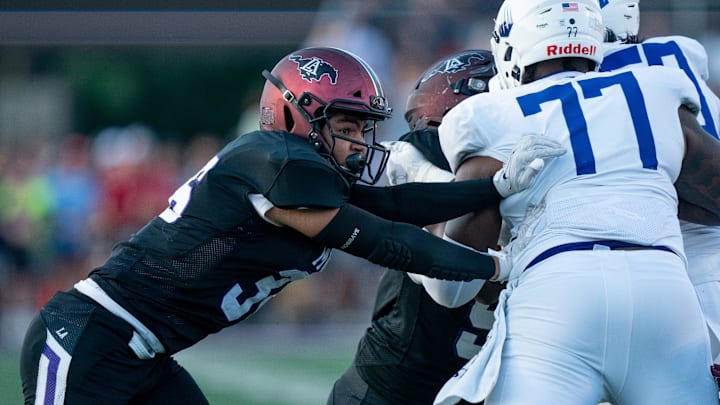 Lipscomb's Michael Hubbell (36) fights past IMG's Jordan Seaton (77) at Lipscomb's Reese Smith