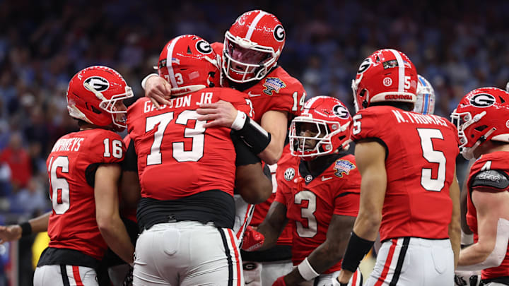 Jan 1, 2026; New Orleans, LA, USA; Georgia Bulldogs quarterback Gunner Stockton (14) celebrates with teammates after scoring a touchdown against the Mississippi Rebels in the second quarter during the 2026 Sugar Bowl and quarterfinal game of the College Football Playoff at Caesars Superdome. Mandatory Credit: Stephen Lew-Imagn Images