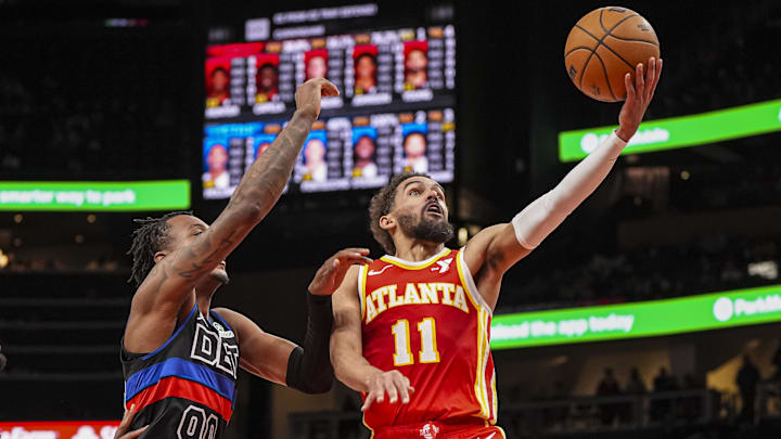 Jan 22, 2025; Atlanta, Georgia, USA; Atlanta Hawks guard Trae Young (11) goes to the basket past Detroit Pistons forward Ronald Holland II (00) during the second half at State Farm Arena. Mandatory Credit: Dale Zanine-Imagn Images
