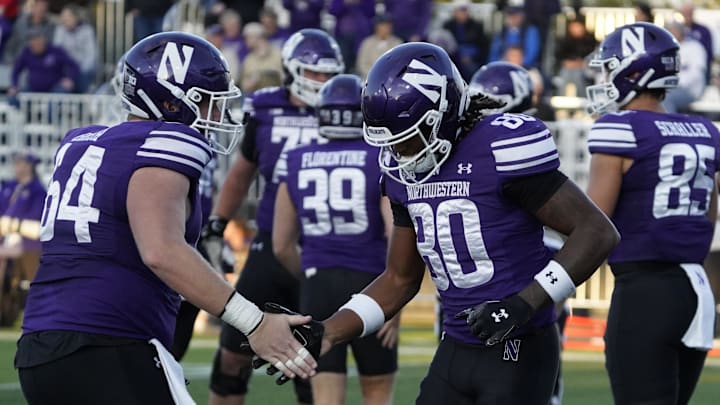 Sep 5, 2025; Evanston, Illinois, USA; Northwestern Wildcats wide receiver Hayden Eligon II (80) celebrates his touchdown against the Western Illinois Leathernecks with offensive lineman Anthony Birsa (64) during the first half at Northwestern Medicine Field at Martin Stadium. Mandatory Credit: David Banks-Imagn Images