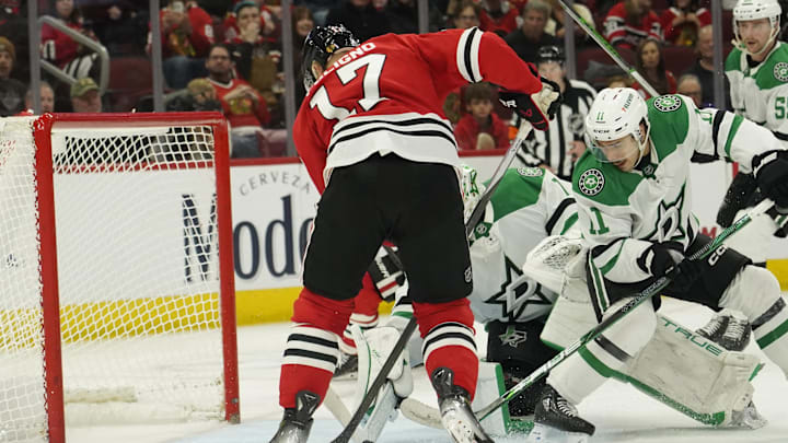Nov 27, 2024; Chicago, Illinois, USA; Dallas Stars defenseman Ilya Lyubushkin (46) and Chicago Blackhawks left wing Nick Foligno (17) battle for the puck during the third period at United Center. Mandatory Credit: David Banks-Imagn Images