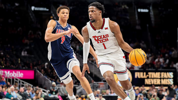Mar 14, 2025; Kansas City, MO, USA; Texas Tech Red Raiders guard Kevin Overton (1) brings the ball up court around Arizona Wildcats forward Carter Bryant (9) during the first half at T-Mobile Center. Mandatory Credit: William Purnell-Imagn Images