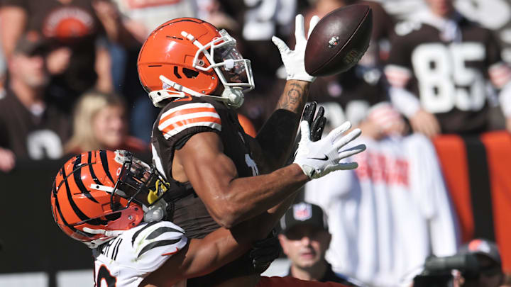 Oct 20, 2024; Cleveland, Ohio, USA; Cincinnati Bengals cornerback DJ Turner II (20) interferes with Cleveland Browns wide receiver Cedric Tillman (19) on a pass play during the first half at Huntington Bank Field. Mandatory Credit: Ken Blaze-Imagn Images