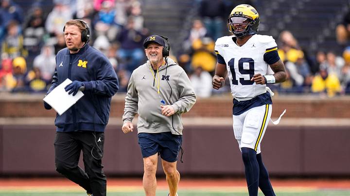 Michigan offensive coordinator Jason Beck, left, head coach Kyle Whittingham, center, and quarterback Bryce Underwood run across the field during the spring game at Michigan Stadium in Ann Arbor on Saturday, April 18, 2026.