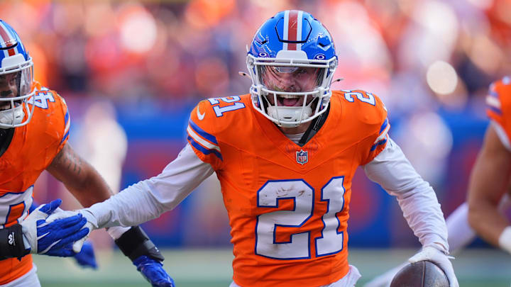 Oct 6, 2024; Denver, Colorado, USA; Denver Broncos cornerback Riley Moss (21) celebrates his interception in the second half against the Las Vegas Raiders at Empower Field at Mile High. Mandatory Credit: Ron Chenoy-Imagn Images