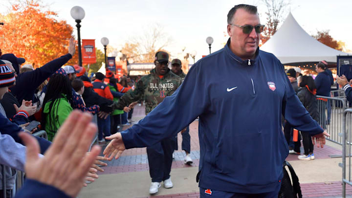 Nov 2, 2024; Champaign, Illinois, USA; Illinois Fighting Illini head coach Bret Bielema gets a hand from the crowd before the start of a game with the Minnesota Golden Gophers at Memorial Stadium. Mandatory Credit: Ron Johnson-Imagn Images Nov 2, 2024; Champaign, Illinois, USA; Illinois Fighting Illini head coach Bret Bielema gets a hand from the crowd before the start of a game with the Minnesota Golden Gophers at Memorial Stadium. Mandatory Credit: Ron Johnson-Imagn Images