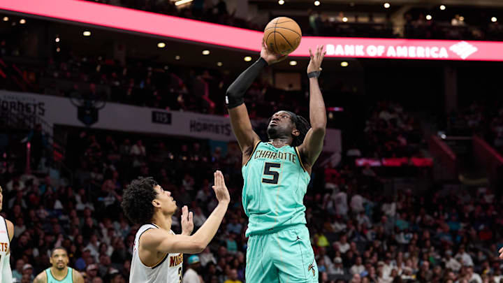 Feb 1, 2025; Charlotte, North Carolina, USA; Charlotte Hornets center Mark Williams (5) shoots over Denver Nuggets guard Julian Strawther (3) during the second half of play at Spectrum Center. Mandatory Credit: Brian Westerholt-Imagn Images