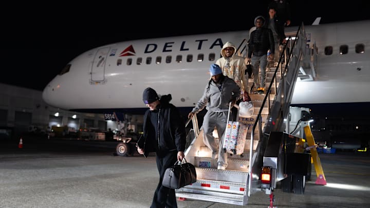 Vikings players exit the plane after landing in New York late Saturday night. 