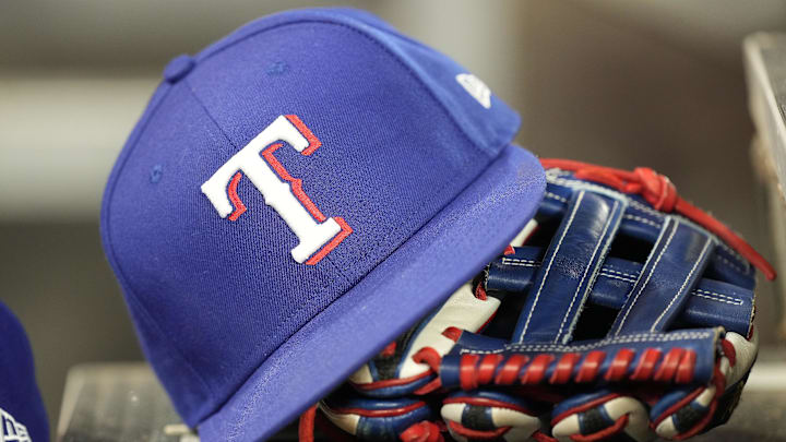 Jul 26, 2024; Toronto, Ontario, CAN; A hat and glove of a Texas Rangers player during a game against the Toronto Blue Jays at Rogers Centre. 