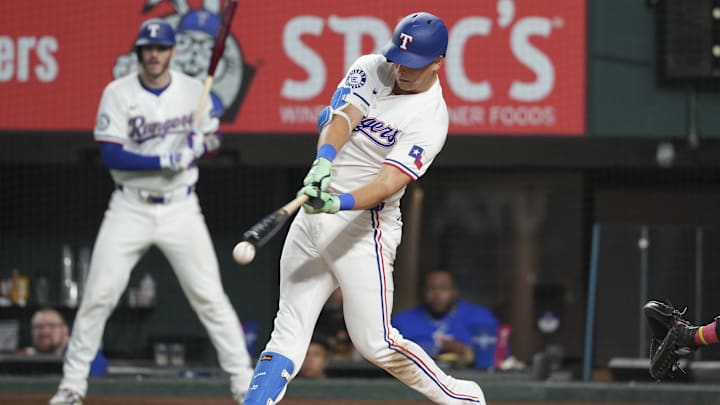 Sep 7, 2024; Arlington, Texas, USA; Texas Rangers first baseman Nathaniel Lowe (30) singles against the Los Angeles Angels during the eighth inning at Globe Life Field.
