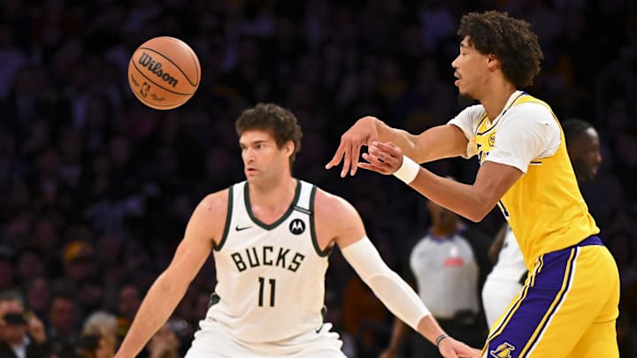 Mar 20, 2025; Los Angeles, California, USA; Los Angeles Lakers center Jaxson Hayes (11) passes against Milwaukee Bucks center Brook Lopez (11) during the first half at Crypto.com Arena. Mandatory Credit: Jonathan Hui-Imagn Images