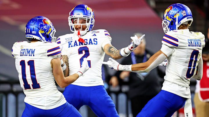 Dec 26, 2023; Phoenix, AZ, USA; Kansas Jayhawks wide receiver Lawrence Arnold (2) celebrates with wide receiver Luke Grimm (11) and wide receiver Quentin Skinner (0) during the second half against the UNLV Rebels in the Guaranteed Rate Bowl at Chase Field. Mandatory Credit: Mark J. Rebilas-USA TODAY Sports Dec 26, 2023; Phoenix, AZ, USA; Kansas Jayhawks wide receiver Lawrence Arnold (2) celebrates with wide receiver Luke Grimm (11) and wide receiver Quentin Skinner (0) during the second half against the UNLV Rebels in the Guaranteed Rate Bowl at Chase Field. Mandatory Credit: Mark J. Rebilas-USA TODAY Sports