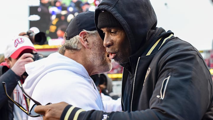 Nov 25, 2023; Salt Lake City, Utah, USA; Colorado Buffaloes head coach Deion 'Coach Prime' Sanders congratulates Utah Utes head coach Kyle Whittingham after the Utah Utes victory over the Colorado Buffaloes at Rice-Eccles Stadium. Mandatory Credit: Christopher Creveling-Imagn Images