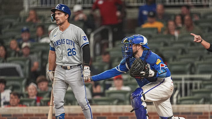 Sep 28, 2024; Cumberland, Georgia, USA; Atlanta Braves catcher Travis d'Arnaud (16) tags out Kansas City Royals second baseman Adam Frazier (26) after a dropped third strike during the sixth inning at Truist Park. Mandatory Credit: Dale Zanine-Imagn Images