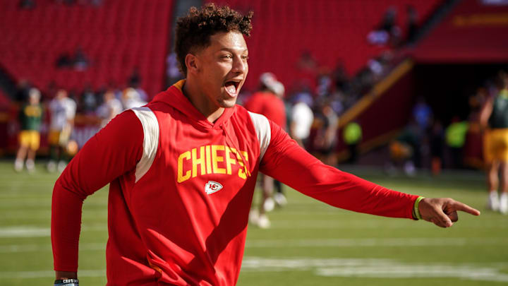 Aug 25, 2022; Kansas City, Missouri, USA; Kansas City Chiefs quarterback Patrick Mahomes (15) laughs after catching a pass over tight end Travis Kelce (not pictured) during warm ups before a preseason game against the Green Bay Packers at GEHA Field at Arrowhead Stadium. Mandatory Credit: Denny Medley-Imagn Images