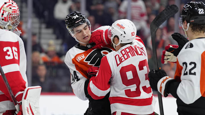 Apr 2, 2026; Philadelphia, Pennsylvania, USA; Philadelphia Flyers right wing Porter Martone (94) scuffles with Detroit Red Wings right wing Alex Debrincat (93) in the second period at Xfinity Mobile Arena. Mandatory Credit: Kyle Ross-Imagn Images