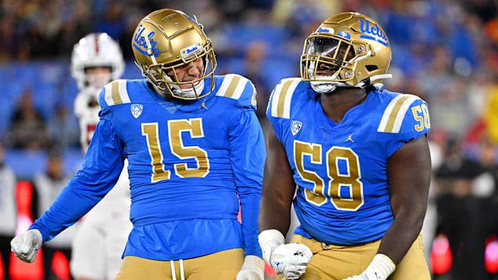 Oct 29, 2022; Pasadena, California, USA;  UCLA Bruins linebacker Laiatu Latu (15) and defensive lineman Gary Smith III (58) celebrate after a sack of Stanford Cardinal quarterback Tanner McKee (18)  in the first half at the Rose Bowl. Mandatory Credit: Jayne Kamin-Oncea-Imagn Images
