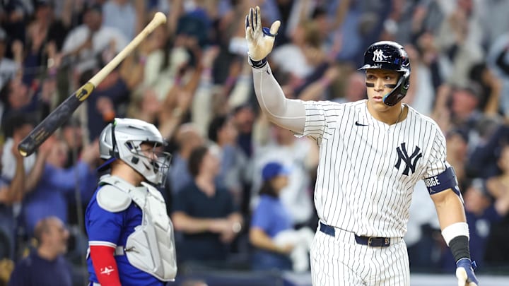Oct 7, 2025; Bronx, New York, USA; New York Yankees outfielder Aaron Judge (99) flips his bat after hitting a three-run home run in the fourth inning against the Toronto Blue Jays during game three of the ALDS round for the 2025 MLB playoffs at Yankee Stadium. Mandatory Credit: Wendell Cruz-Imagn Images