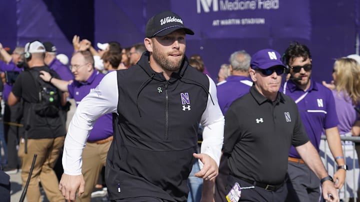 Oct 5, 2024; Evanston, Illinois, USA; Northwestern Wildcats head coach David Braun takes the field against the Indiana Hoosiers at Lanny and Sharon Martin Stadium. Mandatory Credit: David Banks-Imagn Images Oct 5, 2024; Evanston, Illinois, USA; Northwestern Wildcats head coach David Braun takes the field against the Indiana Hoosiers at Lanny and Sharon Martin Stadium. Mandatory Credit: David Banks-Imagn Images