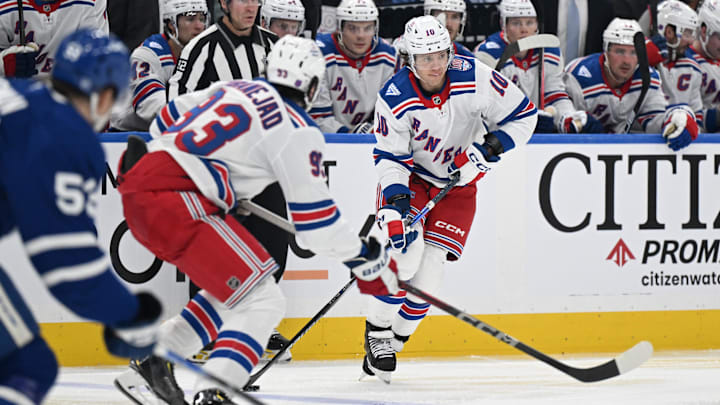 Oct 16, 2025; Toronto, Ontario, CAN; New York Rangers forward Artemi Panarin (10) moves the puck up ice with forward Mika Zibanejad (93) in the third period at Scotiabank Arena. Mandatory Credit: Dan Hamilton-Imagn Images