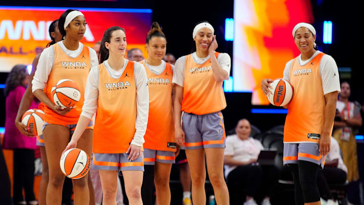 July 19, 2024; Phoenix, Ariz., U.S.; Sky forward Angel Reese (L) and Fever guard Caitlin Clark (second from left) stand with their teammates as they shoot half court shots during WNBA All-Star practice on Media Day at the Footprint Center. July 19, 2024; Phoenix, Ariz., U.S.; Sky forward Angel Reese (L) and Fever guard Caitlin Clark (second from left) stand with their teammates as they shoot half court shots during WNBA All-Star practice on Media Day at the Footprint Center.