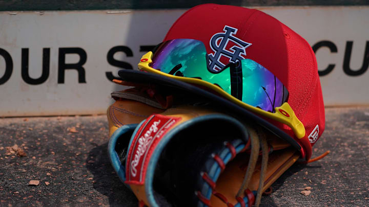 Mar 20, 2018; Jupiter, FL, USA; A St. Louis Cardinals hat with sunglasses sits on a glove in the dugout during a spring training game against the New York Mets at Roger Dean Stadium. Mandatory Credit: Jasen Vinlove-Imagn Images Mar 20, 2018; Jupiter, FL, USA; A St. Louis Cardinals hat with sunglasses sits on a glove in the dugout during a spring training game against the New York Mets at Roger Dean Stadium. Mandatory Credit: Jasen Vinlove-Imagn Images