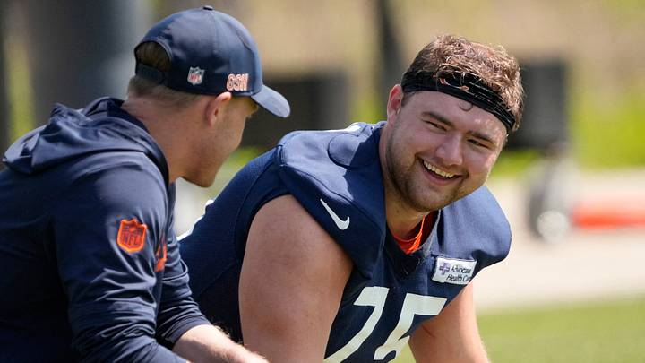 Chicago Bears head coach Ben Johnson talks with offensive lineman (75) Ozzy Trapilo. Chicago Bears head coach Ben Johnson talks with offensive lineman (75) Ozzy Trapilo.