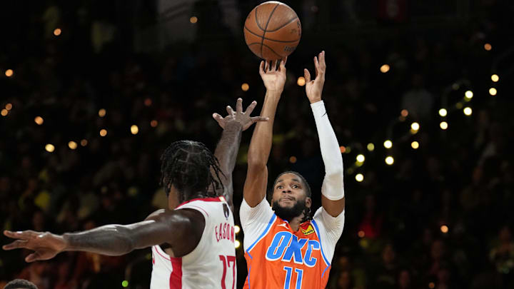 Dec 14, 2024; Las Vegas, Nevada, USA; Oklahoma City Thunder guard Isaiah Joe (11) shoots against Houston Rockets forward Tari Eason (17) during the first half in a semifinal of the 2024 Emirates NBA Cup at T-Mobile Arena. Mandatory Credit: Kyle Terada-Imagn Images