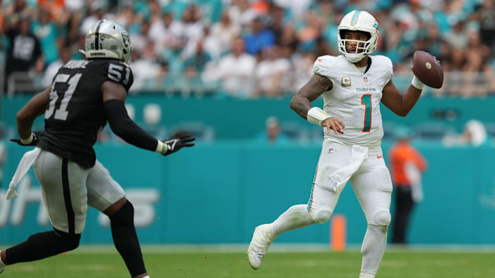 Miami Dolphins quarterback Tua Tagovailoa (1) looks to pass as Las Vegas Raiders defensive end Malcolm Koonce (51) closes in during the second half of an NFL game at Hard Rock Stadium in Miami Gardens, Nov. 19, 2023.