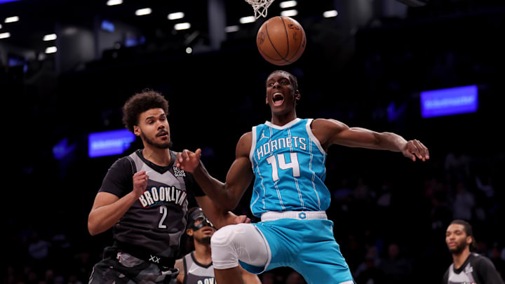 Feb 10, 2025; Brooklyn, New York, USA; Charlotte Hornets forward Moussa Diabate (14) reacts after a dunk against Brooklyn Nets forward Cameron Johnson (2) during the first quarter at Barclays Center. Mandatory Credit: Brad Penner-Imagn Images