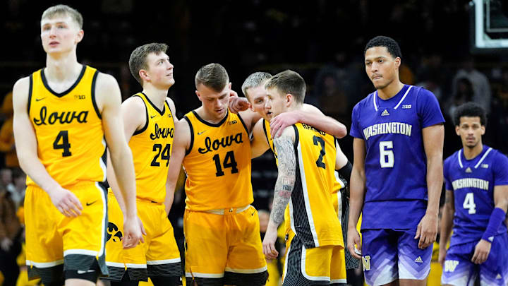 The Iowa Hawkeyes huddle as Iowa Hawkeyes guard Josh Dix (4) prepares the shoot free throws in the final minutes against the Washington Huskies Saturday, Feb. 22, 2025 at Carver-Hawkeye Arenain Iowa City, Iowa.
