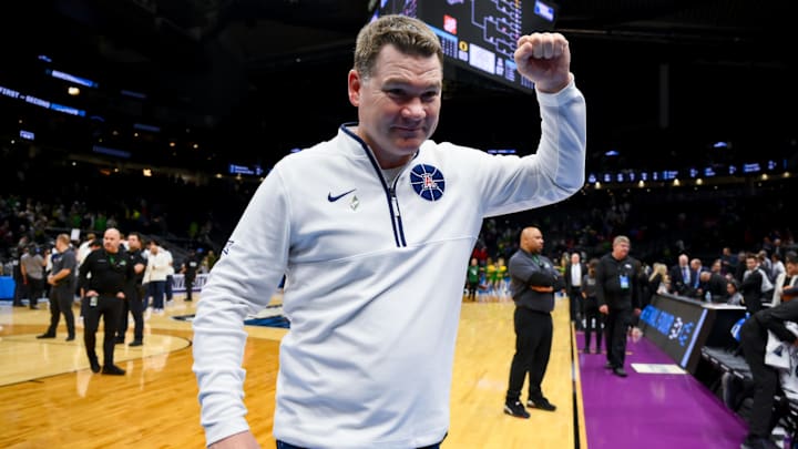 Mar 23, 2025; Seattle, WA, USA;  Arizona Wildcats head coach Tommy Lloyd celebrates after defeating the Oregon Ducks at Climate Pledge Arena. Mandatory Credit: Stephen Brashear-Imagn Images