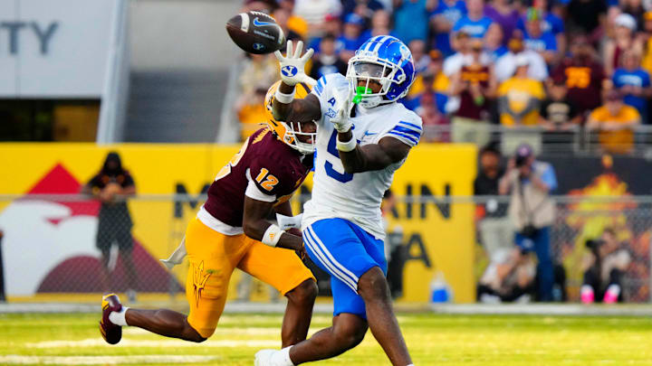 BYU wide receiver Darius Lassiter (5) makes a catch against Arizona State defensive back Javan Robinson (12) during the second half at Mountain America Stadium in Tempe on Nov. 23, 2024. BYU wide receiver Darius Lassiter (5) makes a catch against Arizona State defensive back Javan Robinson (12) during the second half at Mountain America Stadium in Tempe on Nov. 23, 2024.