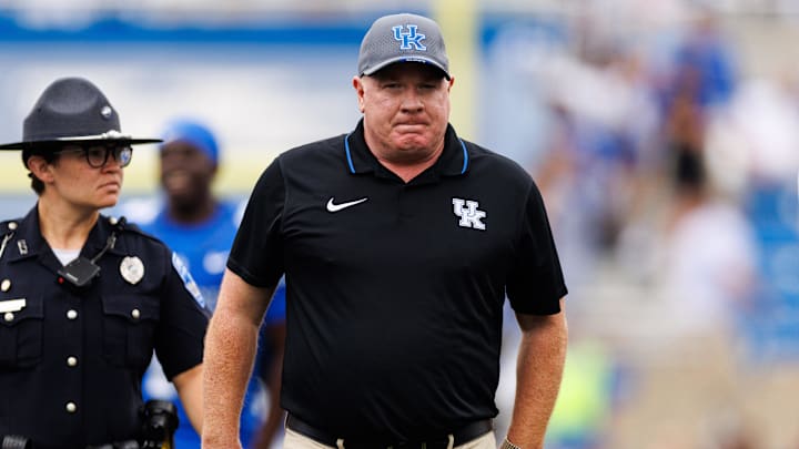 Sep 21, 2024; Lexington, Kentucky, USA; Kentucky Wildcats head coach Mark Stoops walks onto the field before the game against the Ohio Bobcats at Kroger Field. Mandatory Credit: Jordan Prather-Imagn Images Sep 21, 2024; Lexington, Kentucky, USA; Kentucky Wildcats head coach Mark Stoops walks onto the field before the game against the Ohio Bobcats at Kroger Field. Mandatory Credit: Jordan Prather-Imagn Images