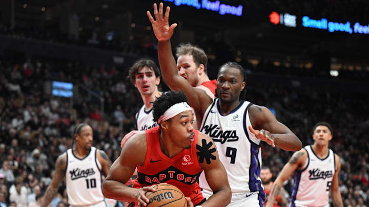 Apr 1, 2026; Toronto, Ontario, CAN;  Toronto Raptors forward Scottie Barnes (4) looks for a way past Sacramento Kings forward Precious Achiuwa (9) in the second half at Scotiabank Arena. Mandatory Credit: Dan Hamilton-Imagn Images