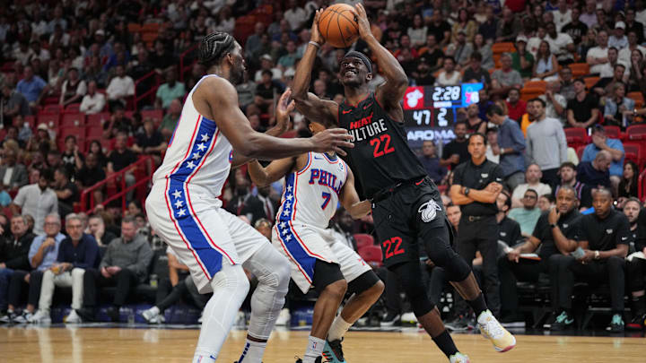Apr 4, 2024; Miami, Florida, USA;  Miami Heat forward Jimmy Butler (22) goes up for a shot as Philadelphia 76ers center Joel Embiid (21) defends during the first half at Kaseya Center. Mandatory Credit: Jim Rassol-USA TODAY Sports