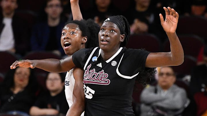 Mar 22, 2025; Los Angeles, California, USA;  California Golden Bears forward Ugonne Onyiah (0) and Mississippi State Bulldogs center Madina Okot (15) fight for position under the basket during the 2nd quarter of an NCAA Tournament game at Galen Center. Mandatory Credit: Robert Hanashiro-Imagn Images